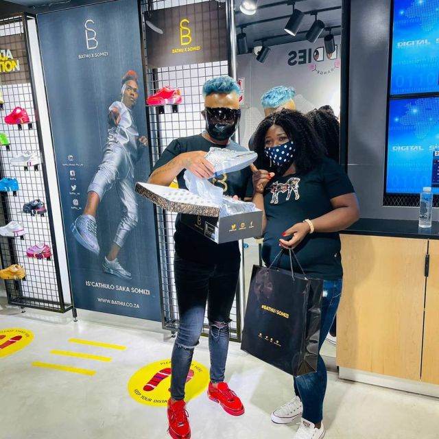 Somizi helps customers try on his new sneakers – Photos